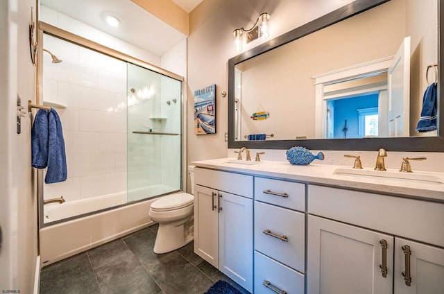 full bathroom featuring bath / shower combo with glass door, vanity, and toilet