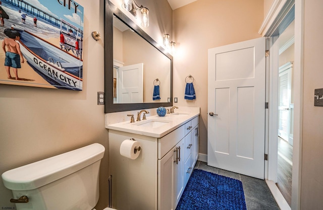 bathroom featuring vanity, toilet, and tile patterned flooring