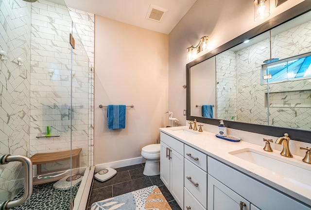 bathroom with tile patterned flooring, vanity, a shower with door, and toilet