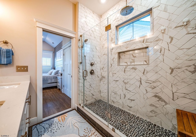 bathroom featuring vanity, an enclosed shower, vaulted ceiling, and wood-type flooring