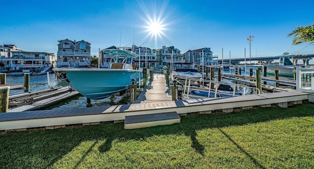 dock area featuring a water view and a yard