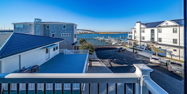 view of pool featuring a water view and central AC unit