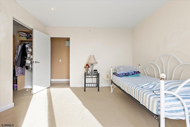 bedroom with light colored carpet and a closet