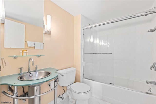 bathroom featuring toilet, tile patterned floors, and shower / bath combination with glass door