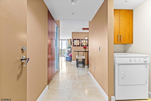 laundry room featuring washer / clothes dryer and cabinets