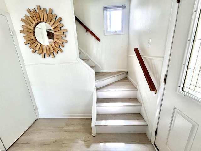 staircase with hardwood / wood-style floors