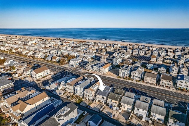 aerial view featuring a water view and a beach view