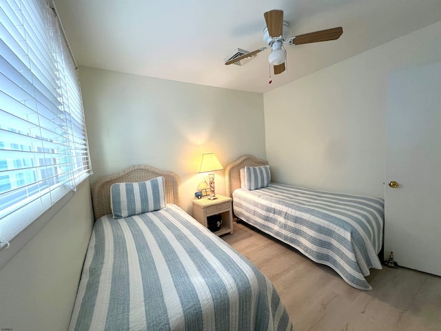 bedroom with ceiling fan and light hardwood / wood-style flooring