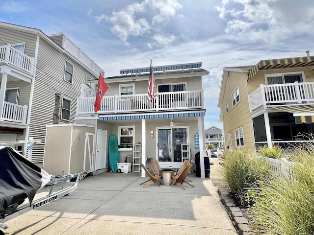 back of property featuring a patio area and a balcony