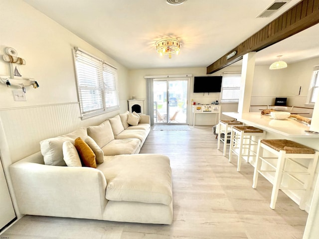 living room featuring light hardwood / wood-style floors and a wealth of natural light