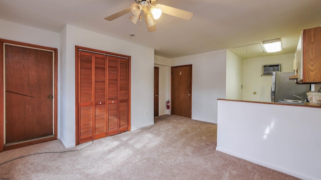 interior space with light carpet, stainless steel fridge, and ceiling fan