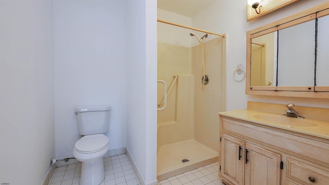 bathroom featuring vanity, tile patterned floors, toilet, and walk in shower