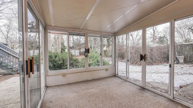 unfurnished sunroom featuring lofted ceiling