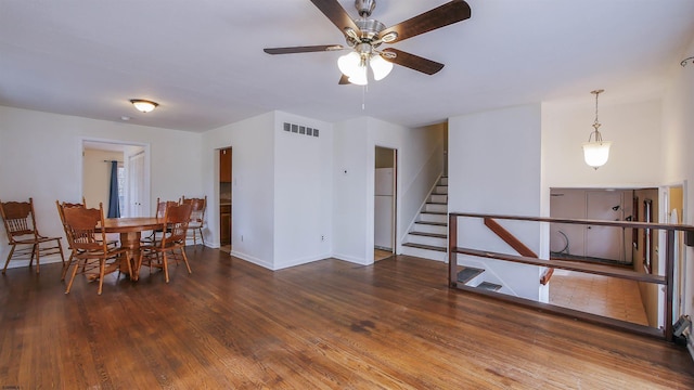 unfurnished dining area featuring dark wood-type flooring and ceiling fan