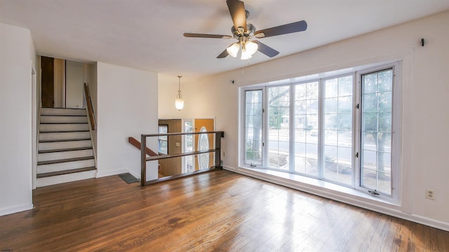 spare room with ceiling fan and dark hardwood / wood-style floors