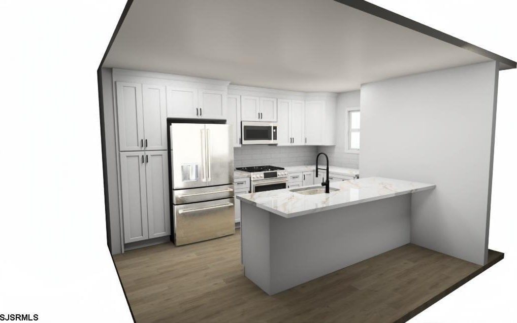 kitchen featuring white cabinetry, sink, light stone counters, kitchen peninsula, and stainless steel appliances