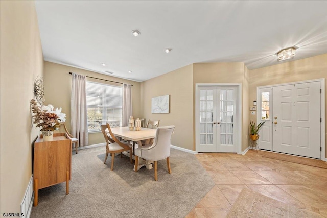 dining space with french doors, light tile patterned flooring, and baseboards