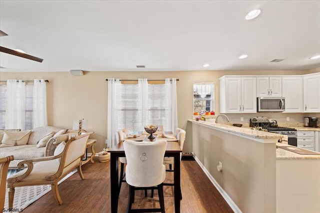 dining area with plenty of natural light, visible vents, dark wood finished floors, and recessed lighting