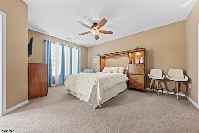 carpeted bedroom featuring visible vents, baseboards, and a ceiling fan