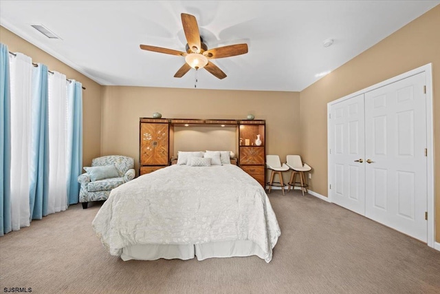 bedroom with a ceiling fan, light colored carpet, visible vents, and baseboards