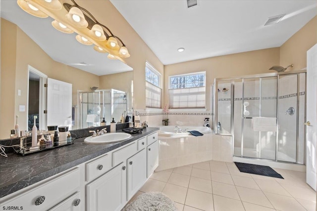 bathroom featuring a stall shower, visible vents, a garden tub, tile patterned flooring, and vanity