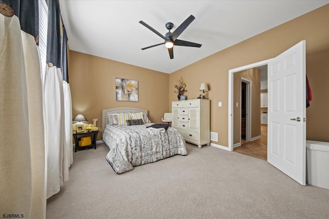 bedroom with a ceiling fan, visible vents, baseboards, and carpet flooring