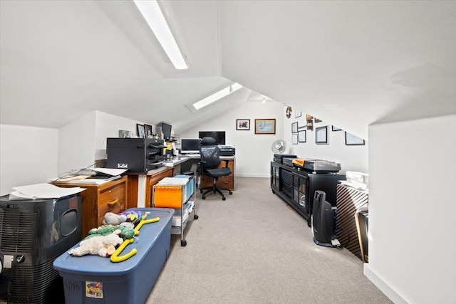 office with light carpet, vaulted ceiling with skylight, and baseboards