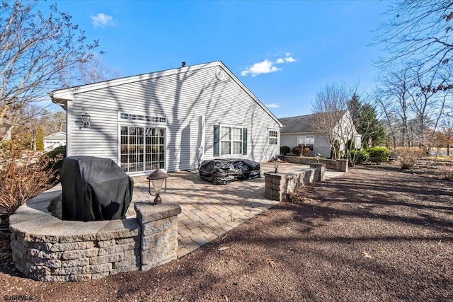 rear view of property featuring a patio area