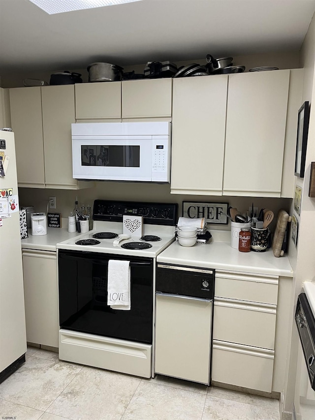 kitchen featuring light tile patterned flooring and white appliances