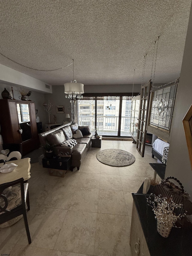 living room featuring a notable chandelier and a textured ceiling