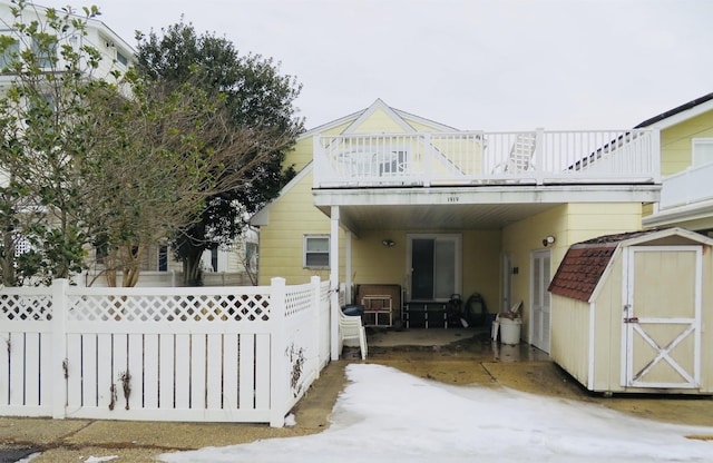 exterior space with a balcony and a shed