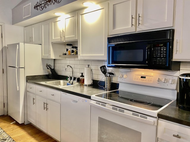 kitchen with sink, light hardwood / wood-style flooring, white appliances, decorative backsplash, and white cabinets