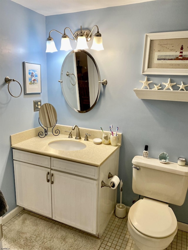 bathroom with tile patterned floors, vanity, and toilet