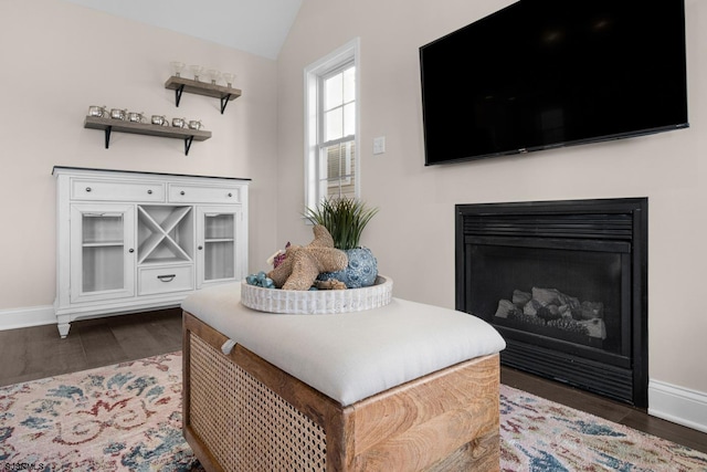 sitting room with lofted ceiling and dark hardwood / wood-style floors