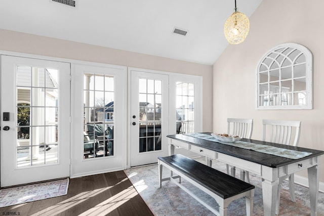 dining area featuring vaulted ceiling and hardwood / wood-style floors