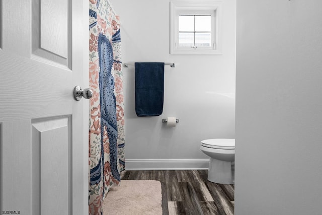 bathroom featuring hardwood / wood-style floors and toilet