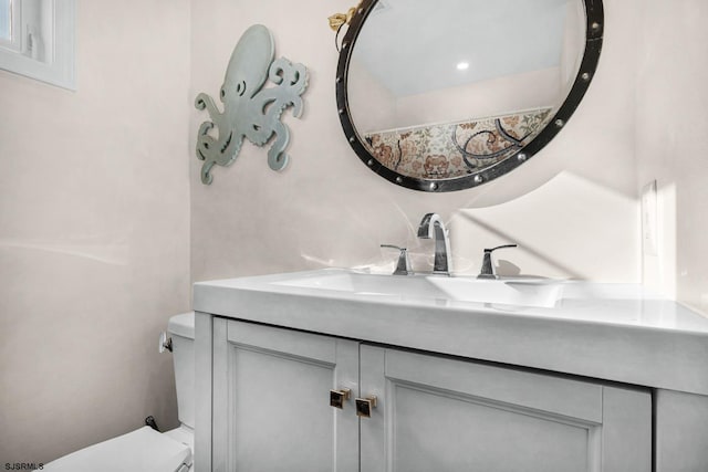 bathroom featuring vanity and toilet