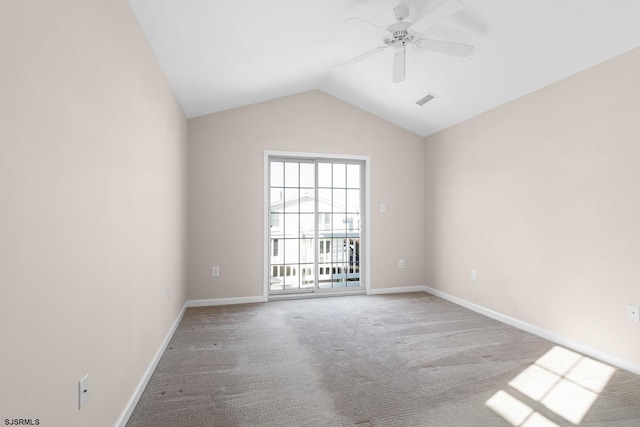 carpeted empty room featuring vaulted ceiling and ceiling fan