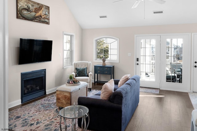 living room featuring vaulted ceiling, ceiling fan, and dark hardwood / wood-style flooring