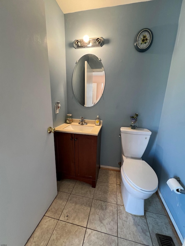 bathroom featuring tile patterned floors, vanity, and toilet