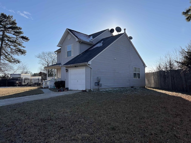 view of side of home featuring a yard and covered porch