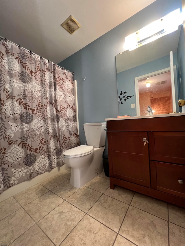 bathroom featuring tile patterned floors, toilet, and vanity