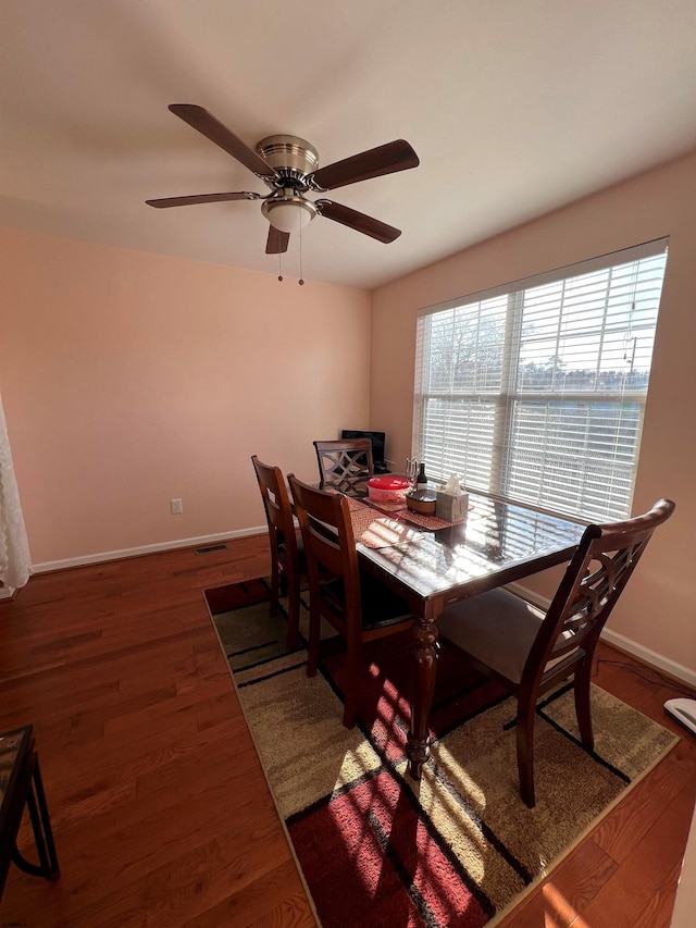 dining room featuring a water view and dark hardwood / wood-style floors