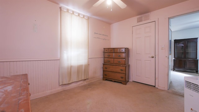 bedroom with light carpet and ceiling fan