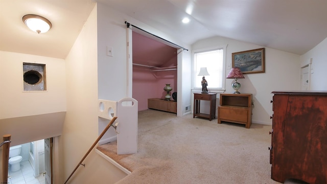 bonus room with lofted ceiling and light carpet