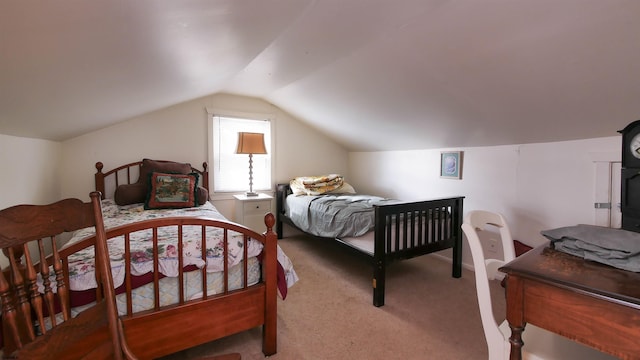 bedroom with vaulted ceiling and light colored carpet