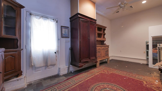 interior space with ceiling fan