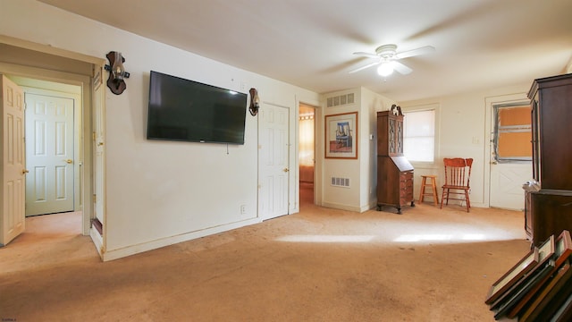 unfurnished living room featuring ceiling fan