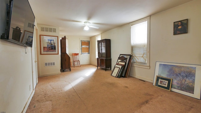 living room with light carpet and ceiling fan