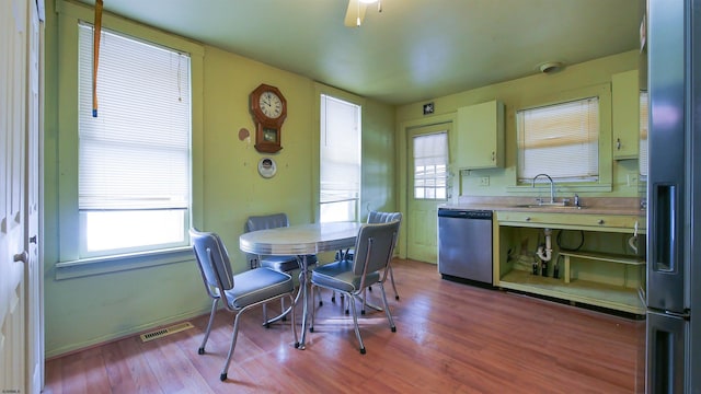 dining space with sink and light hardwood / wood-style floors